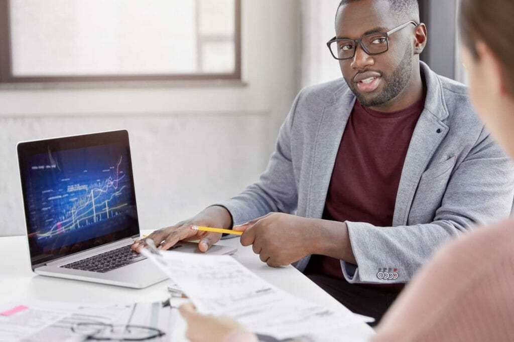 a man sitting at a table using a laptop