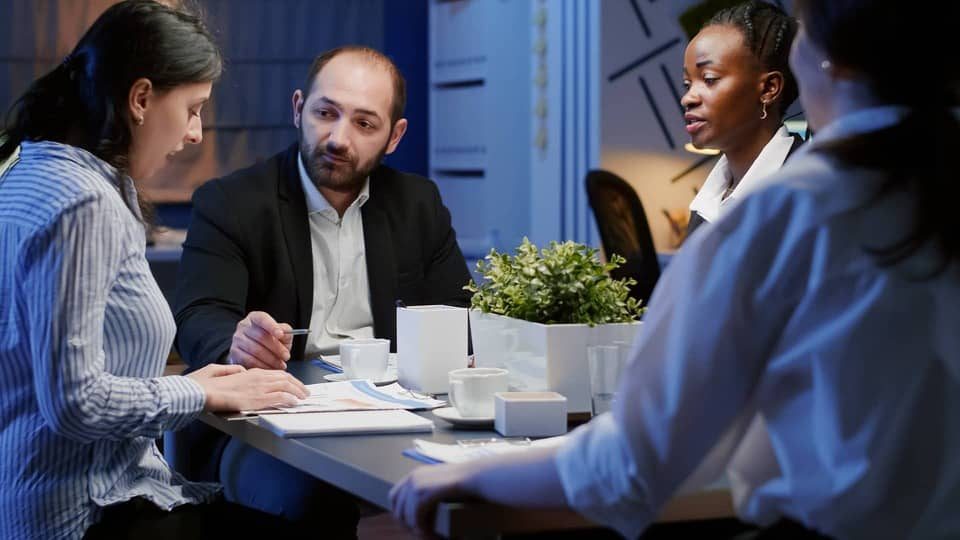 commissioning and providing a group of people sitting at a table